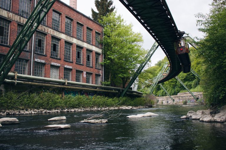 bridge-river-by-buildings-against-sky