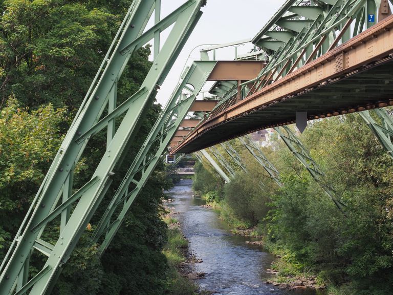 Wuppertaler Schwebebahn (meaning Wuppertal Suspension Railway) above River Wupper is the oldest electric elevated railway with hanging cars in the world in Wuppertal, Germany